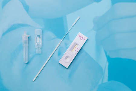 Double exposure Rapid kits of Covid-19 Ag test or ATK seen on blue background with copy space, concept for control of corona virus 2019 epidemic.の写真素材