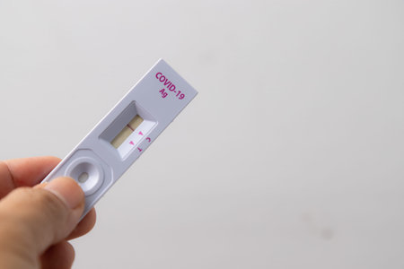 Hand holding Rapid kits of Covid-19 Ag test or ATK seen on white background with copy space, concept...