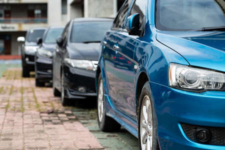 Blue Car parked neatly inside an outdoor parking lot.の写真素材