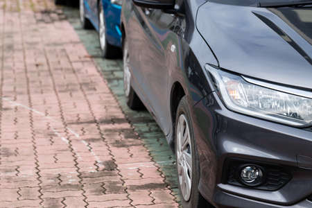 Top view of black Car parked neatly inside an outdoor parking lot.の写真素材