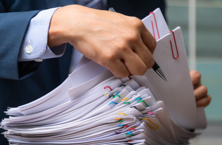 Close-up Businessman signing document after reading the agreement in office, hand writing.の写真素材