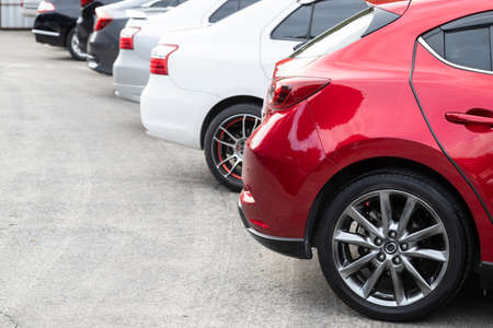 Red car parked neatly inside an outdoor parking lot with copy space.の写真素材