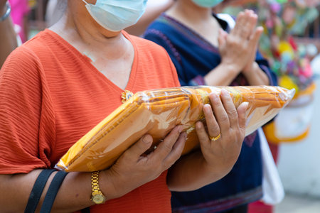 Buddhists holding robes to make meritの写真素材