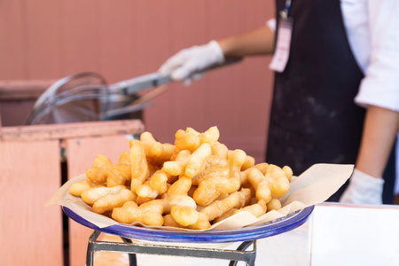 Chinese dough placed for food with employees frying in the background