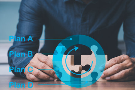 Businessman hand connecting jigsaw puzzle with plan A B C D, Business solutions, concept of strategy and planing.の写真素材