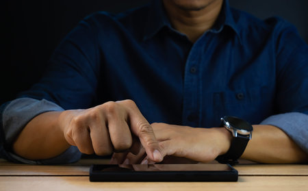 Man hand using cell phone for mobile texting message contact, serach internet information in office...