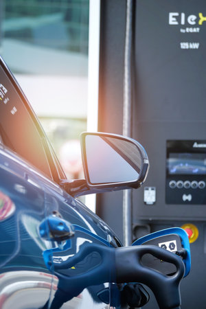 Electric car in EV charging station, concept of green energy and eco power produced from sustainable source to supply to charger station in order to reduce CO2 emission.の写真素材