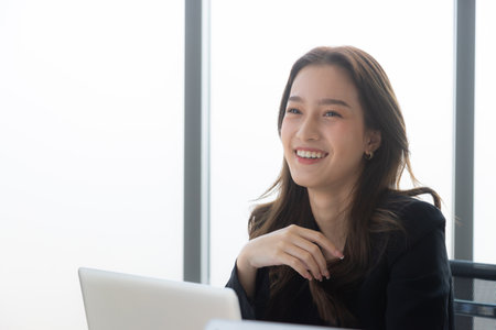 Young female secretary worker smiling unhappy before starting work at office.の写真素材