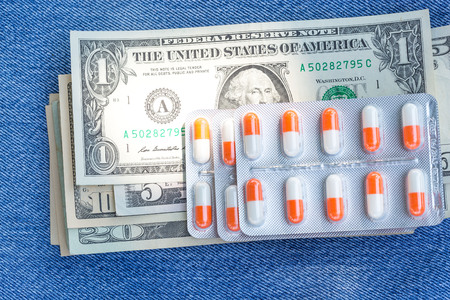 Medicine pills or capsules with money, dollar. Medical or pharmacy prescription for health. Business, finance concept. Cost of the healthy life.の写真素材