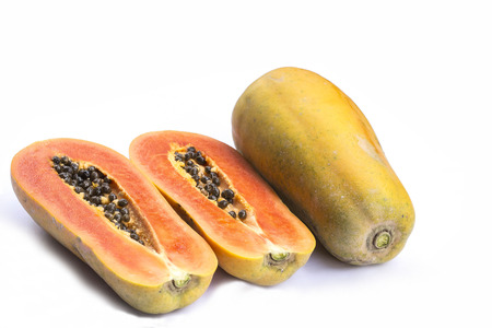 whole and half of ripe papaya fruit with seeds isolated on white backgroundの写真素材