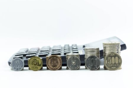 Japanese Yen coins grow up on white background and calculatorの写真素材