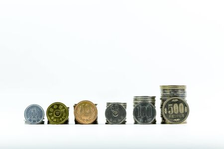 Japanese Yen coins grow up on white backgroundの写真素材