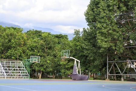 Backstop unit and basketball hoop on basketball court outdoor,under sky with cloudsの写真素材