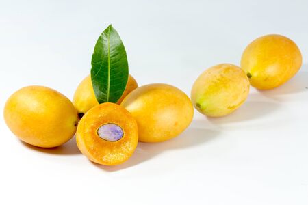 thai fruit Mayongchid Maprang Marian Plum in basket on wood backgroundの写真素材