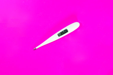 Terumo digital clinical thermometer  for check a feverÂ fight coronavirus on pink background.