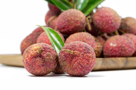 Lychee with leaves isolated on white background. Tropical fruit