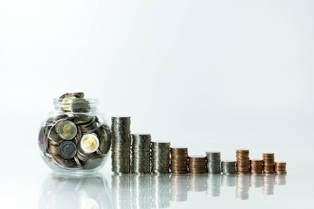 Stack of coin on white  table and blur background, selective focusの写真素材