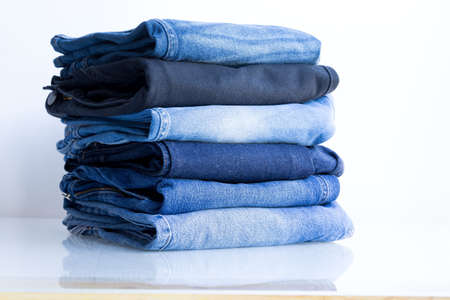 Jeans trousers stack on white backgroundの写真素材