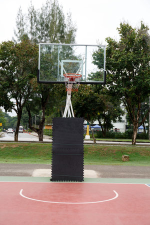 Basketball hoop in outdoor basketball field with blue sky