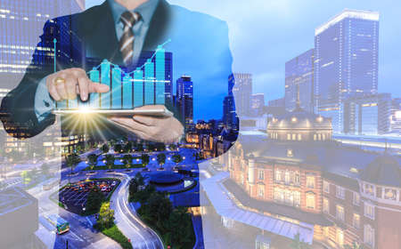 Hot business growth. Businessman using tablet analyzing sales data and economic growth graph chart. Business strategy, financial and banking. Digital marketing.の写真素材