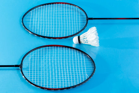 Close up shuttlecocks on racket badmintons  on skyblue bacground.