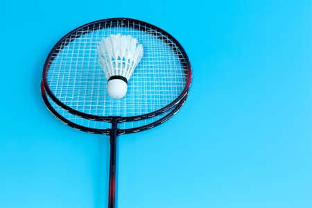 badminton racket and shuttlecock on sky blue field background.の写真素材