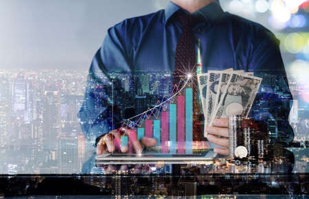 Businessman using phone analysis sales data and economic growth graph chart and stack coins, Business strategy. Innovative. Digital marketing.の写真素材