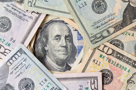 Benjamin Ben Franklin face on US 100 dollar bill closeup on banknote, United States of America money...