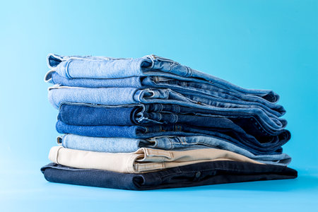 Stack of blue jeans in a shop and supermarket.の写真素材