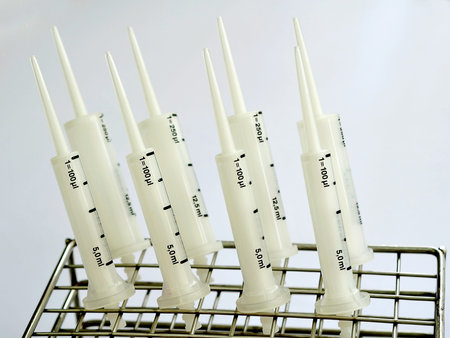 A white syringe pipets with rack