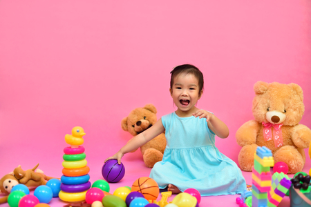 Cute Asian girl playing toys in living roomの写真素材