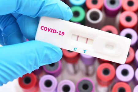 Positive test result by using rapid test device for COVID-19 virusの写真素材