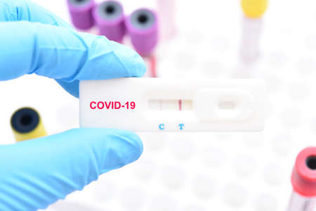 Positive test result by using rapid test device for COVID-19 virusの写真素材