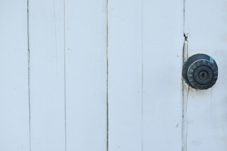 Door handle keyhole on white wood doorの写真素材