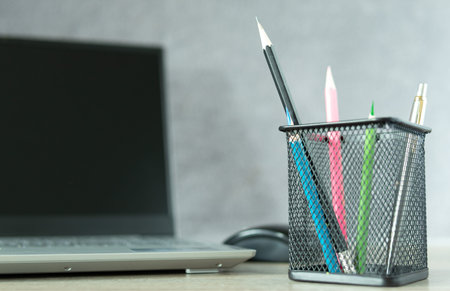 Black basket with blue pencil Ready to use with other colored pencils And notebook computers placed...