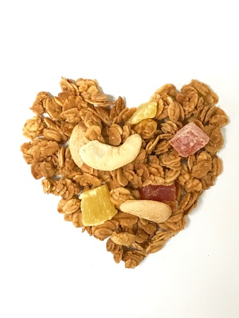 Mixed fruit cornflakes heart white background.の素材