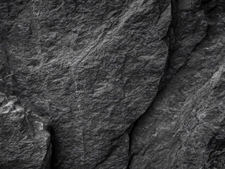 Dark grey stone background or texture. Black stone wall. Close up.