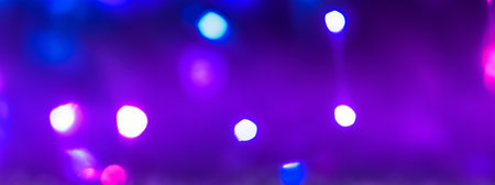 Defocused background with bokeh lights. Purple and blue colors.の写真素材