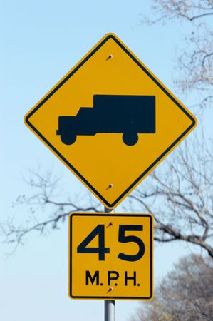 Sign warning that trucks frequently get on the highway aheadの写真素材