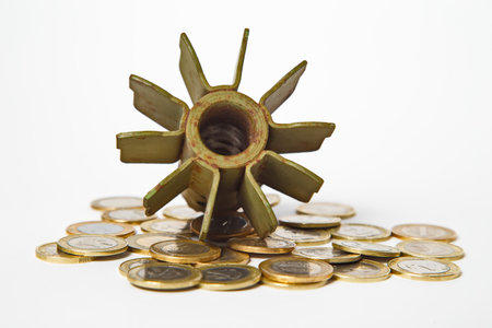 Money for War Concept, Exploded Artillery Shell and coins