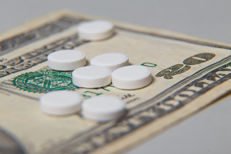 The medical pills are on a moneyの写真素材