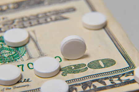The medical pills are on a moneyの写真素材