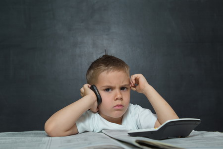 Little boy like businessman in office with newspaper and cellphoneの写真素材