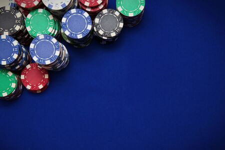 Poker chips on blue table backgroundの写真素材