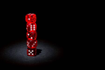 Red dices for gambling on a black backgroundの写真素材