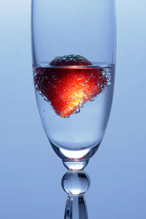 Strawberry in glass with mineral waterの写真素材