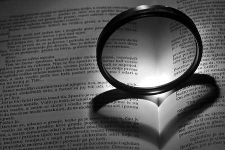 Heart shadow of lens on bookの写真素材