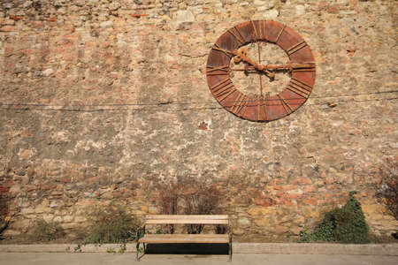 Old rusty clock on wallの写真素材