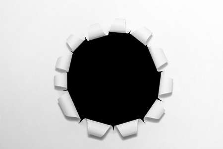 Hole in the white paper の写真素材