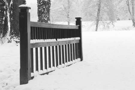 Wooden bridge in forest under snowの写真素材